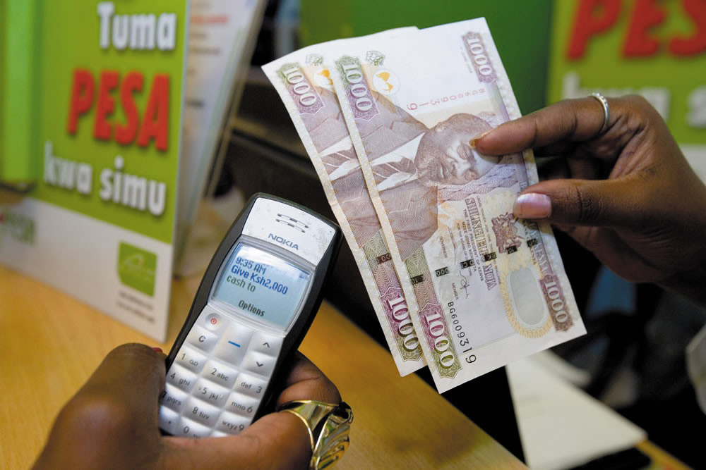 A Nokia 1100 handset with M-Pesa on screen alongside Kenyan banknotes